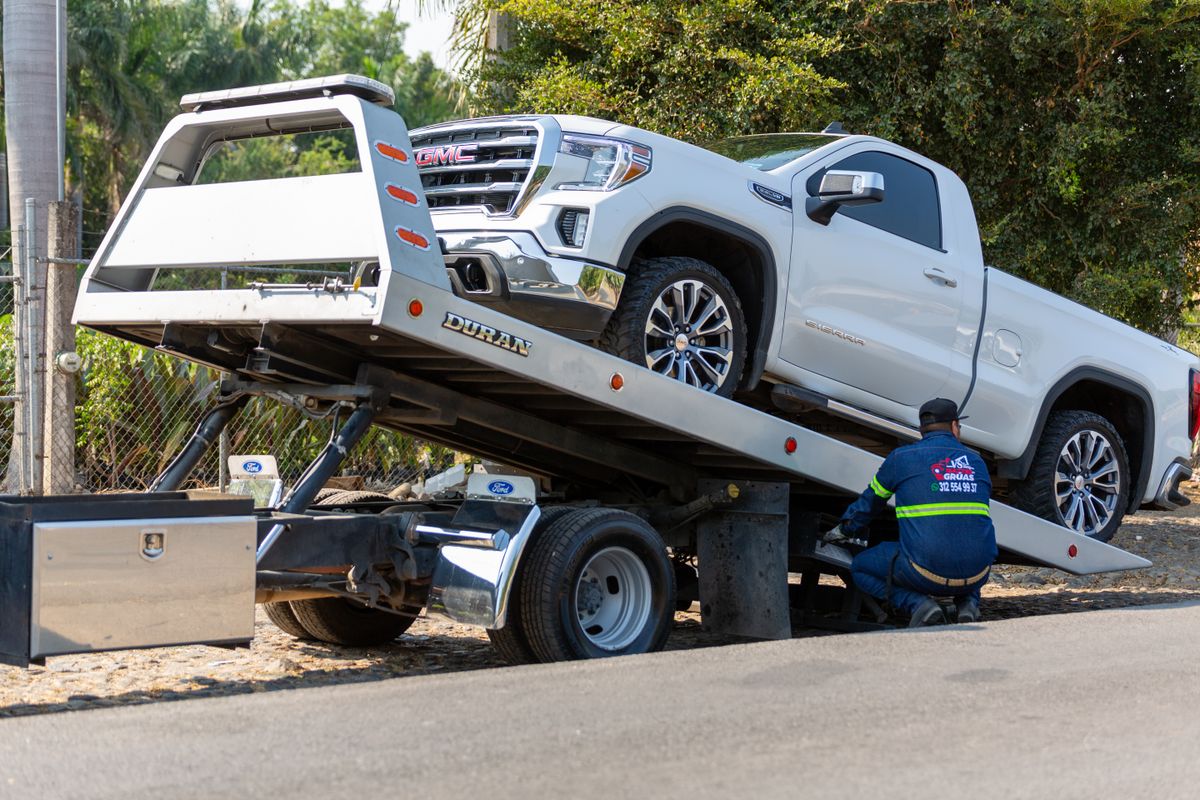 Road assistance vehicle loading a pickup truck