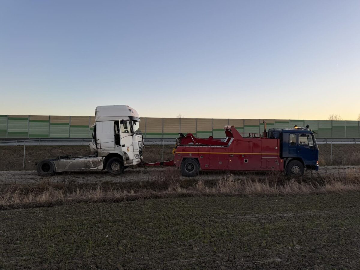 Damaged truck recovered by heavy towing vehicle